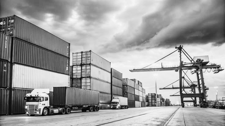 Shipping containers and trucks at a port terminal